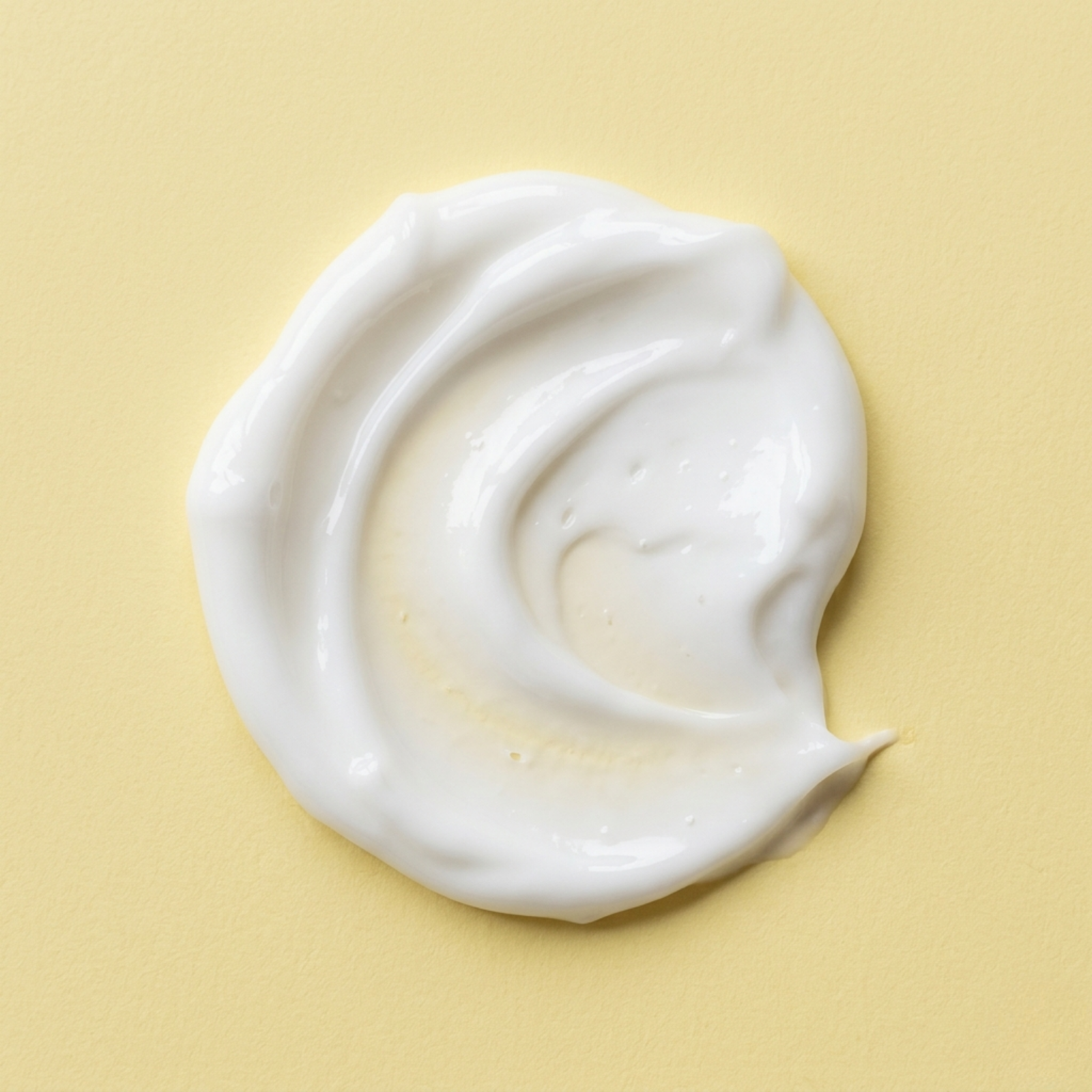 White cream swirl on a beige background