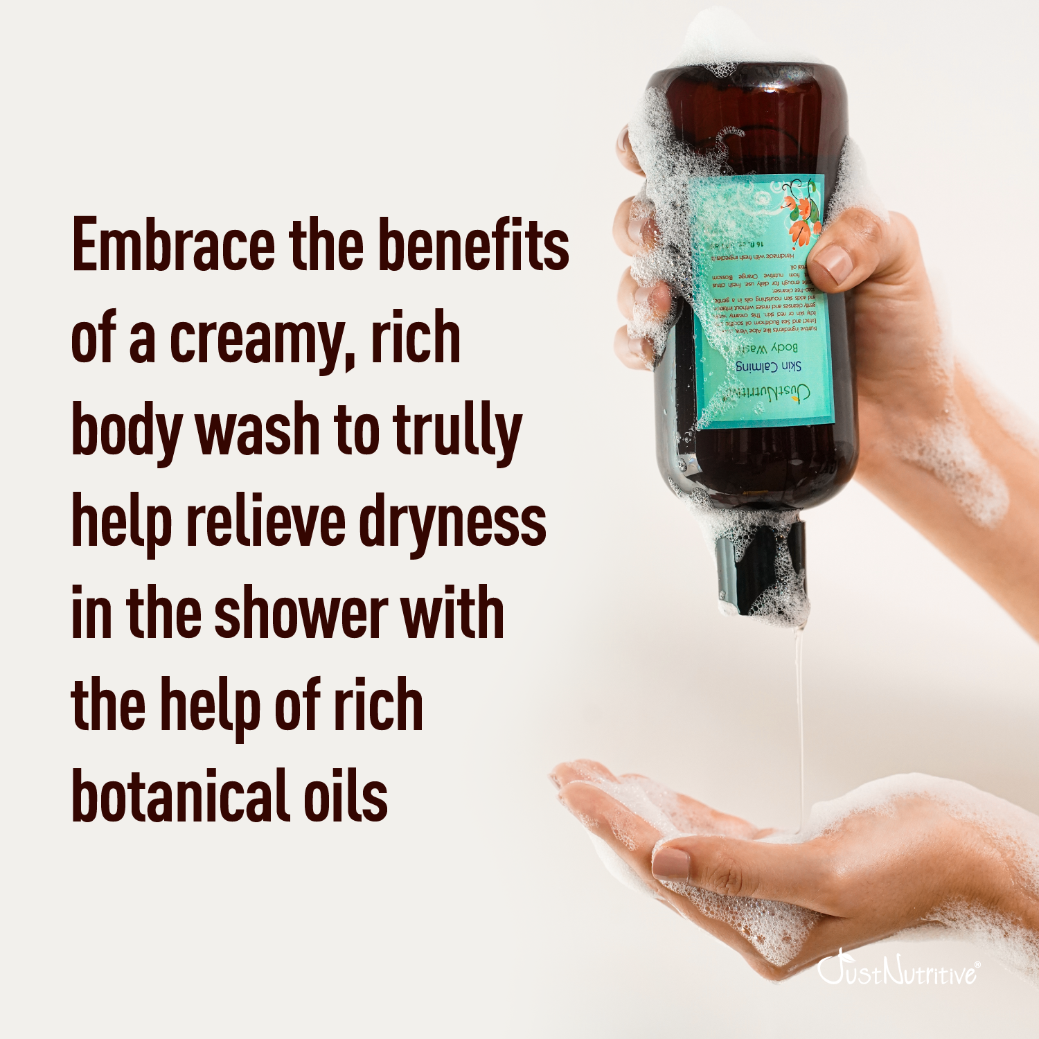 Hand holding a bottle of body wash with text about its benefits