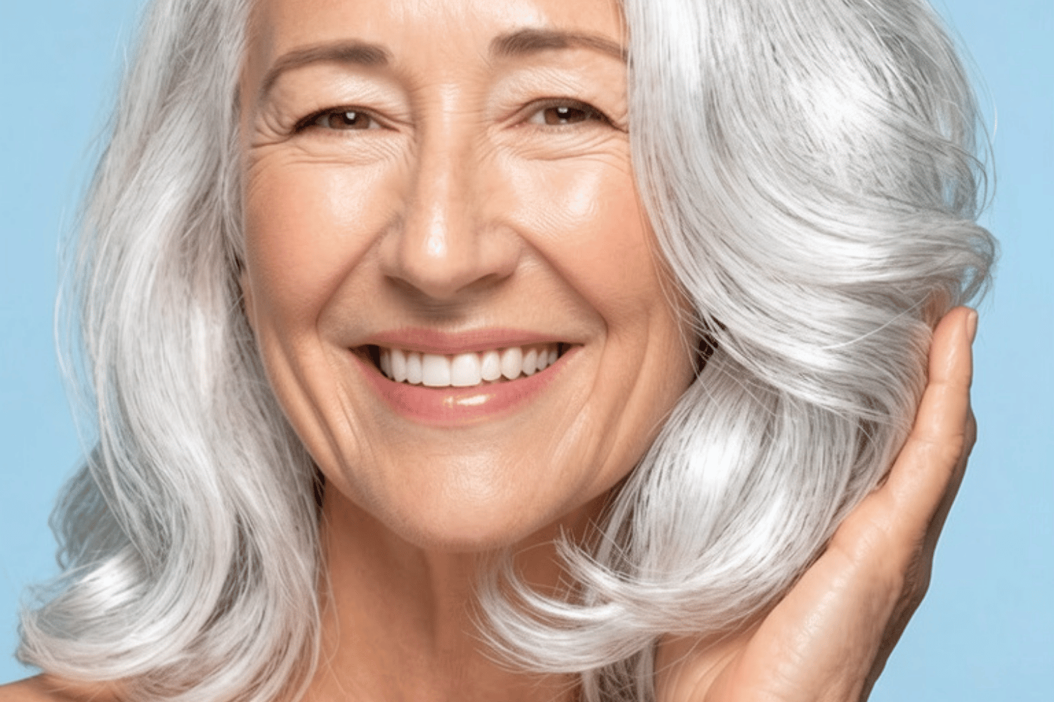 Woman with shiny silver hair, showing how to brighten gray hair naturally.