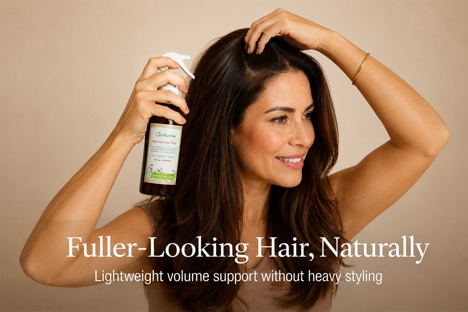woman-holding-volumizer-hair-tonic-tan-background