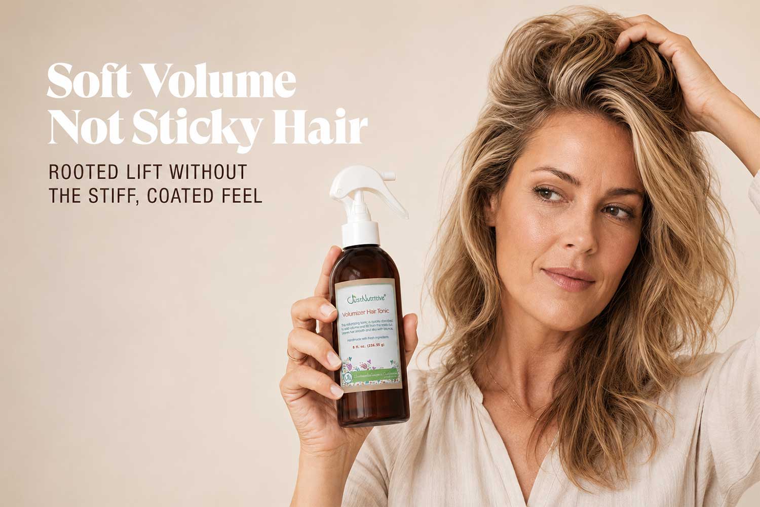woman-holding-volumizer-hair-tonic-tan-background