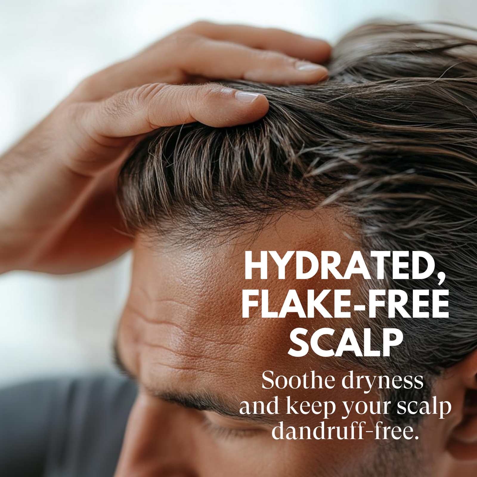 Person touching their scalp with text about hydrated, flake-free scalp