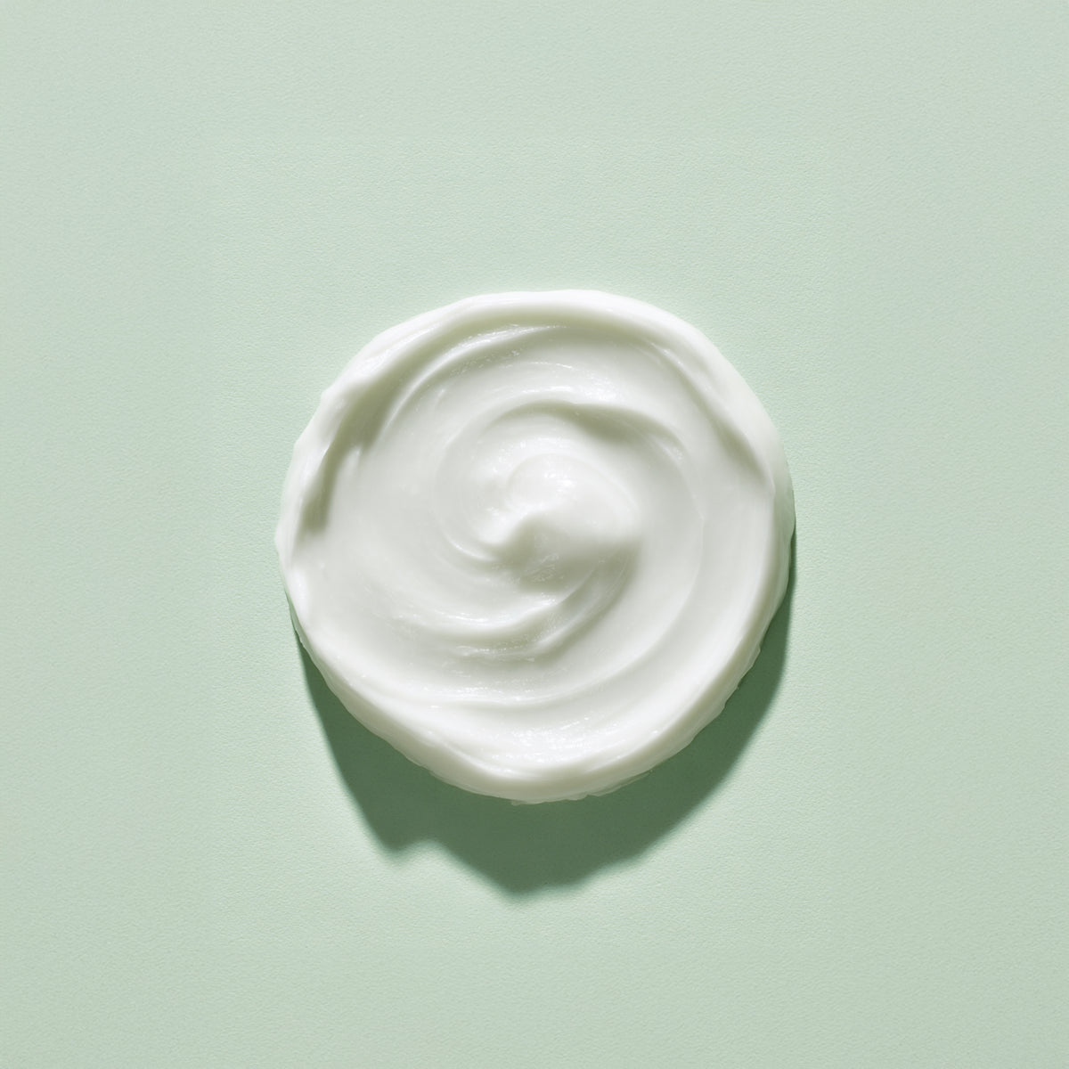 White cream swirl on a light green background