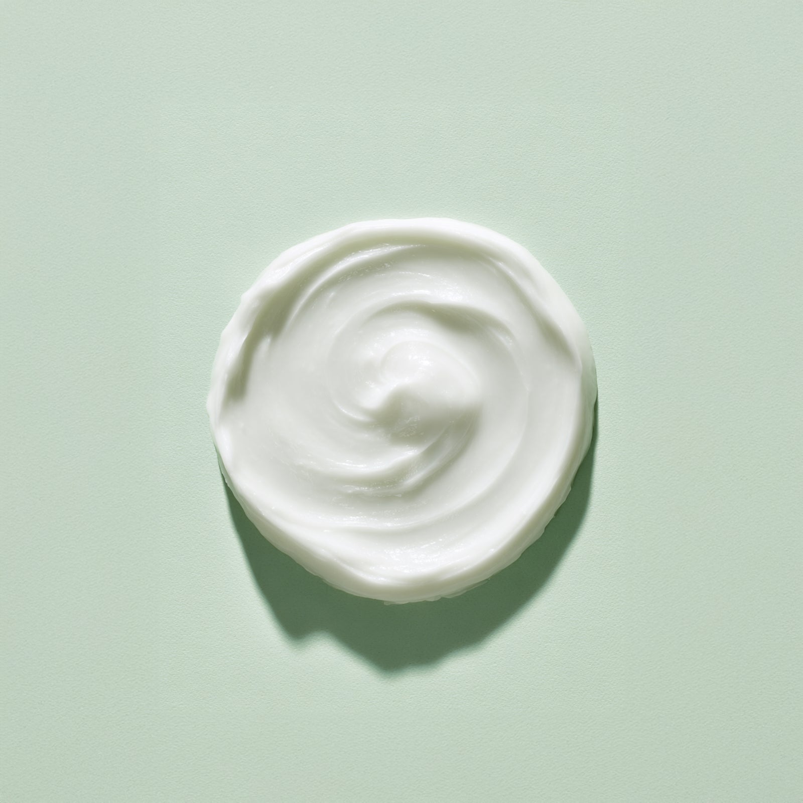 White cream swirl on a light green background