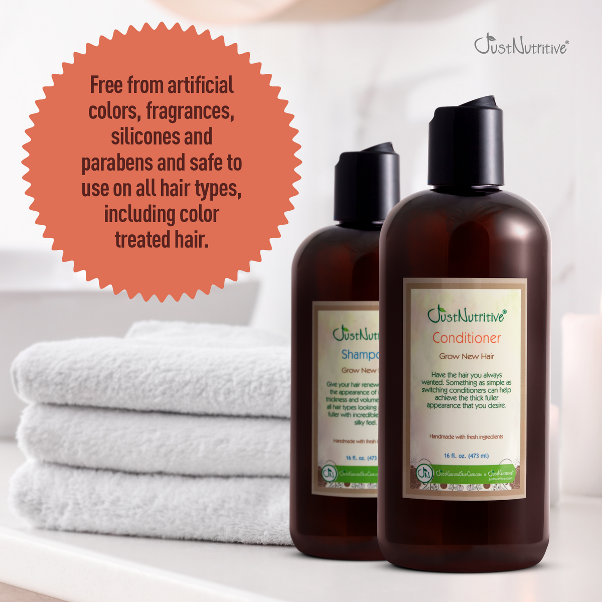 Two bottles of JustNourive shampoo and conditioner with a stack of white towels on a light background.