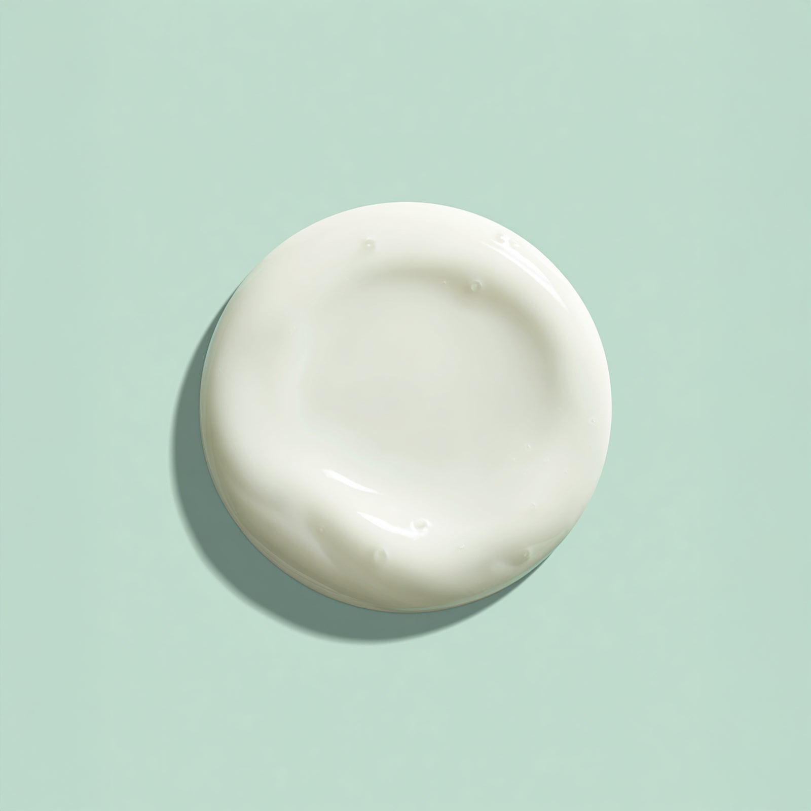 White ceramic plate on a light green background