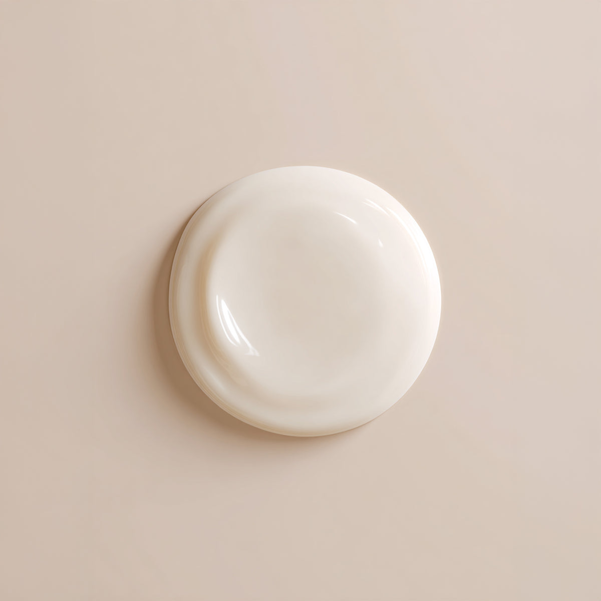 Round white object on a beige background