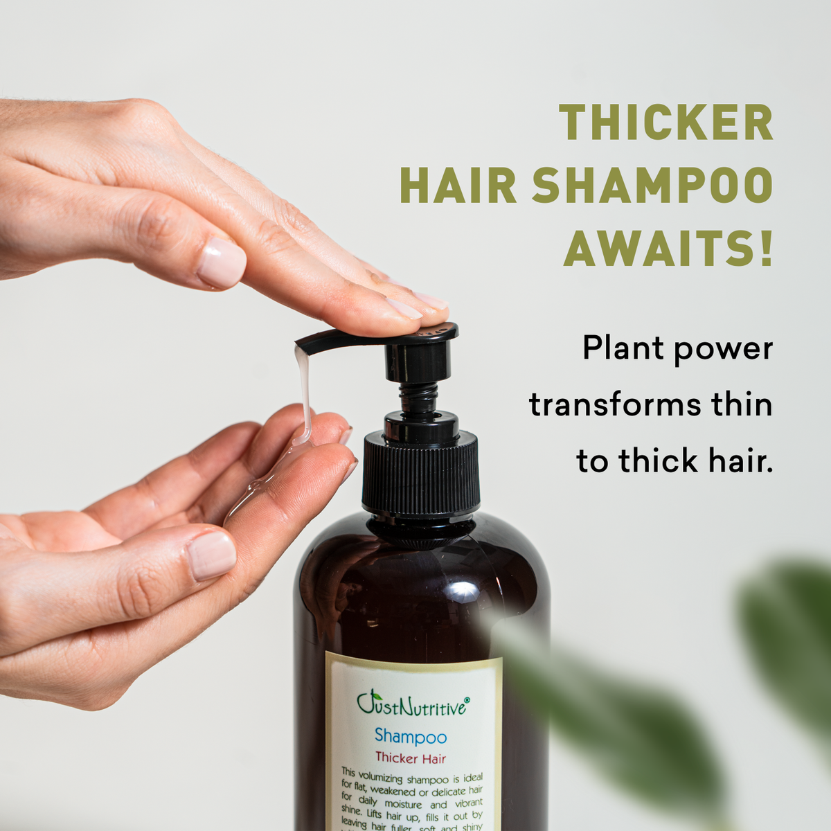 Bottle of 'Just Nurtive' shampoo with a hand holding the pump, on a light background.