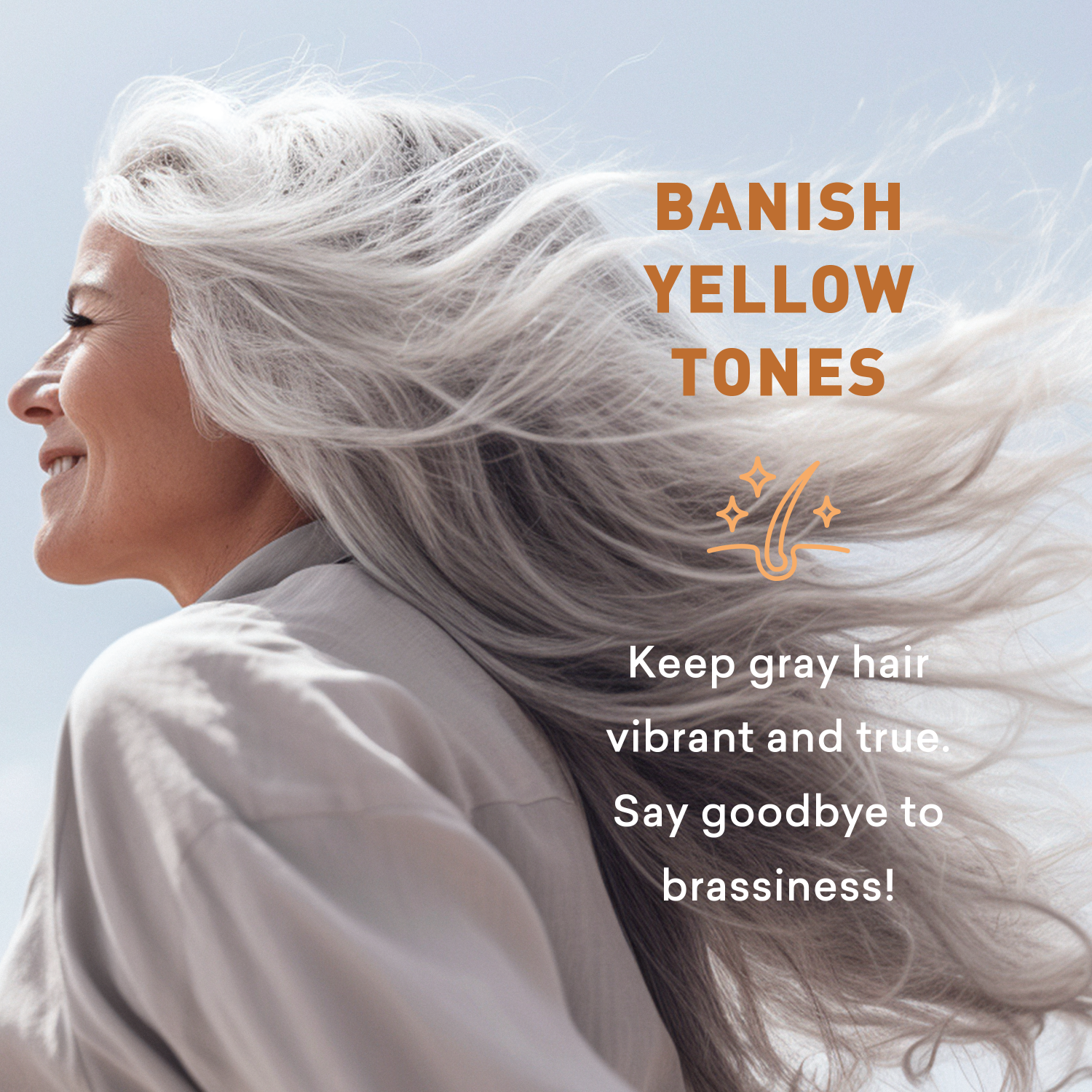 Woman with gray hair against a clear blue sky, promoting hair care product for vibrant gray hair.